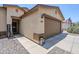 Close up of the home's facade, highlighting the front door, garage, and stone landscaping at 941 E Desert Moon Trl, San Tan Valley, AZ 85143