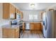 Efficient kitchen featuring stainless steel appliances, ample counter space, and natural wood cabinetry at 941 E Desert Moon Trl, San Tan Valley, AZ 85143