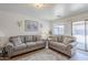 Living room with matching sofa and loveseat, neutral carpet, and natural light at 941 E Desert Moon Trl, San Tan Valley, AZ 85143