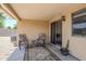 Covered patio area, complete with outdoor seating, and sliding glass door access to the home at 941 E Desert Moon Trl, San Tan Valley, AZ 85143