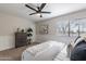 Inviting bedroom featuring ceiling fan, a white textured bedspread, and neutral colors at 1005 N Granite Reef Rd, Scottsdale, AZ 85257