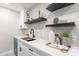 Modern kitchen with open shelving, quartz countertop and undermount sink at 1005 N Granite Reef Rd, Scottsdale, AZ 85257