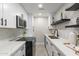 Bright and airy kitchen with white cabinets and stainless steel appliances at 1005 N Granite Reef Rd, Scottsdale, AZ 85257