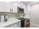 Updated kitchen with stainless steel microwave and stove at 1005 N Granite Reef Rd, Scottsdale, AZ 85257