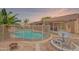 Fenced pool area with gravel landscape, a satellite dish, and a barbecue pit, perfect for outdoor entertaining at 10305 E Dragoon Ave, Mesa, AZ 85208