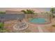 Landscaped backyard with a fenced pool, a satellite dish, and a rock border, perfect for relaxing and enjoying the outdoors at 10305 E Dragoon Ave, Mesa, AZ 85208