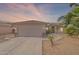 Charming single-story home featuring a two-car garage, desert landscaping, and a tile roof at 10305 E Dragoon Ave, Mesa, AZ 85208
