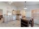 Bright kitchen featuring tile floors, dining table, and light cabinets at 10305 E Dragoon Ave, Mesa, AZ 85208