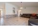 Spacious living room with tile floors and a leather sectional at 10305 E Dragoon Ave, Mesa, AZ 85208