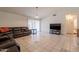 Spacious living room with a leather sectional, tile floors, and a TV at 10305 E Dragoon Ave, Mesa, AZ 85208