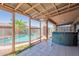 The covered patio area reveals a fenced pool, a jacuzzi, and an open view of the neighboring green space at 10305 E Dragoon Ave, Mesa, AZ 85208