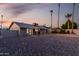Spacious backyard with gravel landscaping, covered patio, and tall palm trees at 1055 E Ingram St, Mesa, AZ 85203