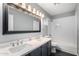 Bathroom featuring dual sinks, modern fixtures, and tub-shower combo with subway tile at 1055 E Ingram St, Mesa, AZ 85203