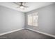 Well-lit bedroom with ceiling fan, neutral color palette and comfortable carpet at 1055 E Ingram St, Mesa, AZ 85203