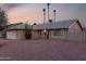 Well-maintained single-story house featuring desert landscaping and palm trees at sunset at 1055 E Ingram St, Mesa, AZ 85203