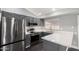 Updated kitchen with stainless steel appliances, granite countertops, and gray cabinetry at 1055 E Ingram St, Mesa, AZ 85203