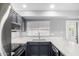 Bright kitchen with gray cabinets, granite countertops, stainless steel appliances, and natural light at 1055 E Ingram St, Mesa, AZ 85203