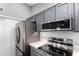 Modern kitchen with stainless steel appliances, granite countertops, and overhead microwave at 1055 E Ingram St, Mesa, AZ 85203