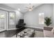 Bright living room with wood floors, neutral walls, a ceiling fan, and an exterior door at 1055 E Ingram St, Mesa, AZ 85203