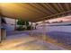 Covered patio featuring decorative posts and a view of the gravel backyard at 1055 E Ingram St, Mesa, AZ 85203
