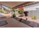 Inviting covered back patio with desert landscaping, perfect for outdoor living at 14420 N 44Th Dr, Glendale, AZ 85306