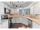 Cozy kitchen with white cabinets, a stainless steel dishwasher, and a view of the backyard at 14420 N 44Th Dr, Glendale, AZ 85306
