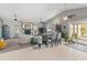 Spacious living room with a fireplace, vaulted ceilings, tile floors, and sliding glass doors to the patio at 14420 N 44Th Dr, Glendale, AZ 85306