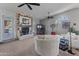 A spacious living room with a fireplace, ceiling fans, vaulted ceilings, and comfortable seating at 14420 N 44Th Dr, Glendale, AZ 85306