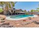 Sparkling swimming pool surrounded by a beautifully landscaped backyard with patio cover at 14420 N 44Th Dr, Glendale, AZ 85306