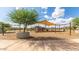 Neighborhood playground with swings, slides, and sun shade to let play all day at 14830 W Soft Wind Cir, Surprise, AZ 85387