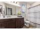 Bathroom features a dark-stained vanity, shower, and tub combination at 17866 W Lilac St, Goodyear, AZ 85338