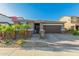 Charming single-story home featuring a well-kept yard with small palm trees, brick accents, and a two-car garage at 17866 W Lilac St, Goodyear, AZ 85338