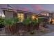 Charming single-story home featuring a well-kept yard with small palm trees, brick accents, and a tile roof at 17866 W Lilac St, Goodyear, AZ 85338