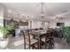 Open-concept kitchen and dining area featuring a large island with bar seating, pendant lights, and stainless appliances at 17866 W Lilac St, Goodyear, AZ 85338