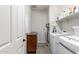 Laundry room with a washer, dryer, cabinet, and extra storage space at 17866 W Lilac St, Goodyear, AZ 85338