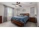 Serene main bedroom featuring a wooden bed frame, soft carpeting, and bright natural light at 17866 W Lilac St, Goodyear, AZ 85338