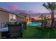 Inviting backyard with lush artificial turf and shimmering pool, perfect for outdoor relaxation and entertainment at 17866 W Lilac St, Goodyear, AZ 85338