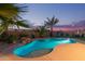 Backyard pool oasis with lush landscaping and comfortable lounge area at 17866 W Lilac St, Goodyear, AZ 85338