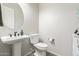 Well-lit powder room with pedestal sink, neutral walls, and modern fixtures at 17866 W Lilac St, Goodyear, AZ 85338