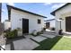 This private backyard offers artificial grass, a patio with modern furniture, and exterior lighting at 1807 E Campbell Ave, Phoenix, AZ 85016