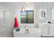 This bright bathroom offers a soaking tub beneath a picture window and modern fixtures at 1807 E Campbell Ave, Phoenix, AZ 85016