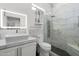 Modern bathroom with a walk-in shower, vanity with quartz countertop and a well-lit mirror at 1807 E Campbell Ave, Phoenix, AZ 85016
