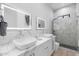 Modern bathroom featuring double vanity, illuminated mirrors, and a luxurious glass-enclosed shower at 1807 E Campbell Ave, Phoenix, AZ 85016