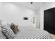 Bedroom with gray and white stripped bedding and dark colored closet doors at 1807 E Campbell Ave, Phoenix, AZ 85016
