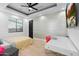 Bedroom with light wood floors, modern ceiling fan, and accent wall at 1807 E Campbell Ave, Phoenix, AZ 85016
