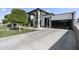 View of modern-style home from the driveway, with concrete paving and artificial lawn at 1807 E Campbell Ave, Phoenix, AZ 85016