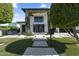 Beautiful front exterior of a modern-style two story home with trimmed trees and green artificial lawn at 1807 E Campbell Ave, Phoenix, AZ 85016