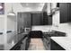 Modern kitchen featuring dark cabinets, stainless steel appliances, and stunning marble countertops at 1807 E Campbell Ave, Phoenix, AZ 85016