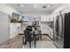 The kitchen offers stainless appliances, white cabinetry, and an eat-in dining space at 1807 E Campbell Ave, Phoenix, AZ 85016