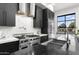 Bright kitchen with stainless steel range, marble backsplash and countertops, and view to backyard at 1807 E Campbell Ave, Phoenix, AZ 85016